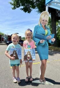 Children standing next to Dolly Parton cutout